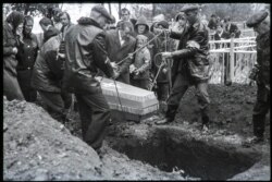 A little girl being buried at an unknown location.