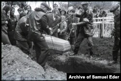 A little girl being buried at an unknown location.