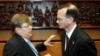 Austria -- Gregory Schulte (R), IAEA envoy of the US, speaks with IAEA Chief Weapons Inspector Olli Heinonen (L) at the beginning of a session of the IAEA Governors Council in Vienna, 8 Mar. 2006