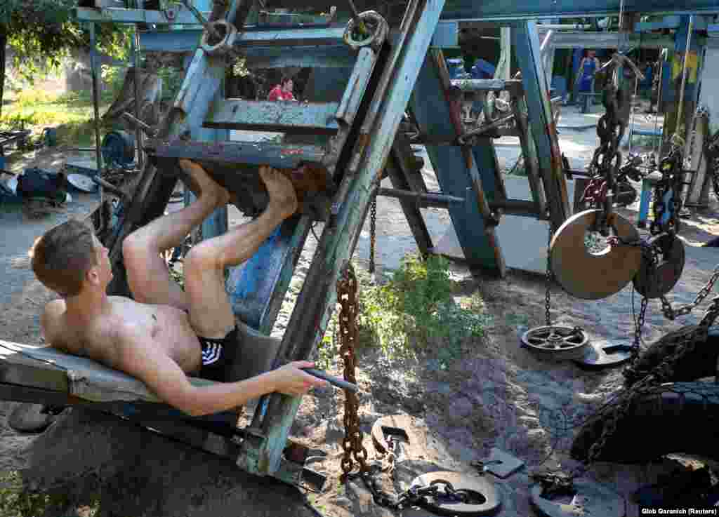 A man pumping iron in the alfresco gym. In 1965, a new subway line across the Dnieper allowed access to the island, which soon became a popular picnic spot.&nbsp;