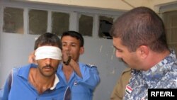 Iraqi police take a suspected member of Al-Qaeda from his cell in Diyala Province. The man was arrested on the basis of a court-issued warrant, something U.S. forces will need for detentions starting January 1. (Photo by Richard Tomkins)