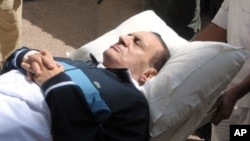 Former Egyptian president Hosni Mubarak appears in court on a stretcher.