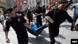 Police officers detain a protester in Moscow last year. According to Freedom House, 2015 saw Russia and other authoritarian regimes "crack down harder on dissent."