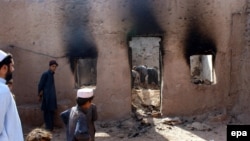 Local residents survey the houses of suspected Taliban militants destroyed by Pakistani security forces during an operation in the Khyber region in March 2010.