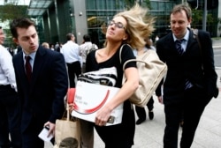 A woman carrying the contents of her desk after being made redundant from Lehman Brothers’ London branch in September 2008.