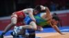 Iran's Hossein Nouri (L) competes with Uzbekistan's Rustam Assakalov in the the men's greco-roman 87kg wrestling gold medal wrestling competition at the 2018 Asian Games in Jakarta on August 22, 2018. / AFP PHOTO / AAMIR QURESHI