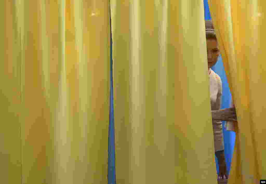 Presidential candidate Yulia Tymoshenko looks out of the polling booth before casting her ballot at a polling station in the east Ukrainian city of Dnipropetrovsk, some 400 kilometers south-east of Kyiv.