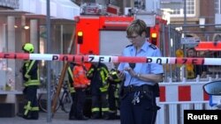 Police block a street near the site where a vehicle drove into a group of people in Muenster Germany, killing two and injuring many. 