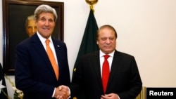 US Secretary of State John Kerry (L) is greeted by Pakistani Prime Minister Nawaz Sharif shortly after arriving in Islamabad on January 12.