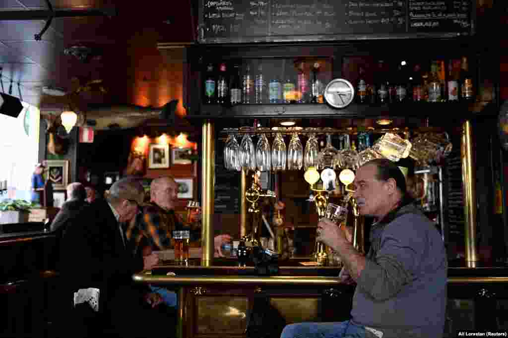 Locals sip beer inside the Half Way Inn, a pub in central Stockholm on March 23.