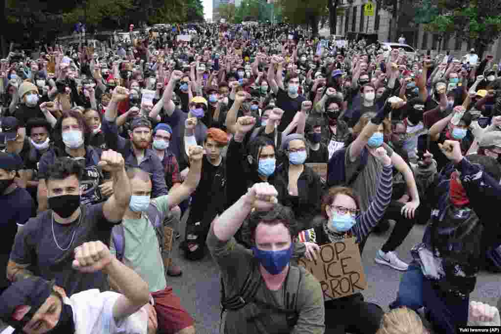 Protesters raise their fist in front of Gracie Mansion, the official residence of the New York mayor, during a protest Tuesday, June 2, 2020, in New York over the death of George Floyd, who died May 25 after he was pinned at the neck by a Minneapolis police officer. (AP Photo/Yuki Iwamura)