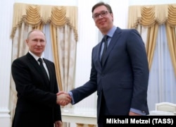 Russian President Vladimir Putin (left) meets with Serbian Prime Minister Aleksandar Vucic at the Kremlin in Moscow on March 27.