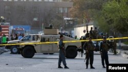 Afghan policemen seal off the site of a suicide bombing in Kabul on April 12.