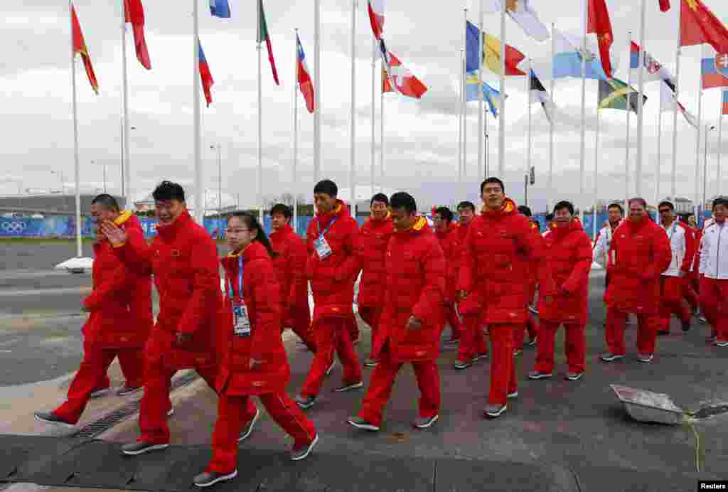 Members of China&#39;s Olympic team wear long, bright red coats, reflecting the color of the communist country&#39;s flag.