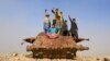 Afghan children play on the remains of a Soviet-era tank on the outskirts of Jalalabad in February.