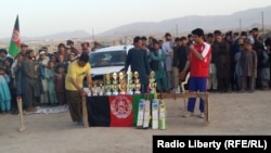 Trophies and medals are being distributed at the end of a cricket competition in Uruzgan.