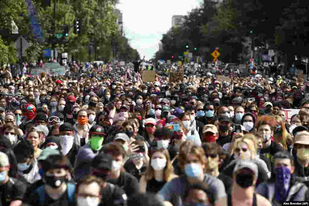 Demonstrators pause to kneel as they march to protest the death of George Floyd, Tuesday, June 2, 2020, in Washington. (AP Photo/Alex Brandon)