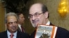 Salman Rushdie (right) poses with his 1988 book &quot;The Satanic Verses&quot; alongside fellow honoree Tashbih Sayyed before the American Jewish Conference&#39;s 30th annual dinner in Beverly Hills, California, in September 2006.