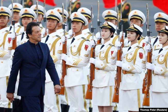 Then-Pakistani Prime Minister Imran Khan reviews a guard of honor during a welcome ceremony in Beijing during a visit to China in 2019.