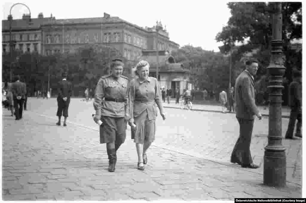 A Soviet soldier strolling central Vienna with a friend in 1946. Vienna's western suburbs were split into British, American, and French sections, while the Soviet Union held Vienna's east.