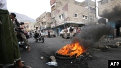 Antiregime activists block a main road in the Yemeni flashpoint city of Taiz.