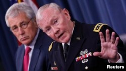 U.S. Chairman of the Joint Chiefs of Staff General Martin Dempsey (right) speaks next to U.S. Secretary of Defense Chuck Hagel during a media briefing at the Pentagon in Washington on July 3.