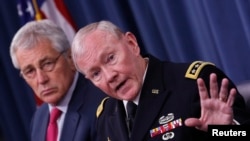 U.S. Chairman of the Joint Chiefs of Staff General Martin Dempsey (right) speaks next to U.S. Secretary of Defense Chuck Hagel during a media briefing at the Pentagon in Washington on July 3.