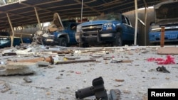 Police vehicles damaged in fighting with Islamic State militants in the Anbar town of Hit on October 6