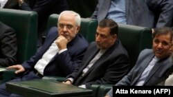 Iran's Foreign Minister Javad Zarif (L), attends a parliament session to discuss the president's proposed cabinet in Tehran, August 15, 2017