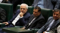 Iran's Foreign Minister Javad Zarif (L), attends a parliament session to discuss the president's proposed cabinet in Tehran, August 15, 2017