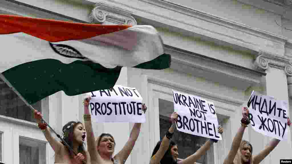 Activists from the Ukrainian women's rights group Femen protest against visa restrictions in front of the residence of the Indian ambassador in Kyiv on January 18. (REUTERS/Gleb Garanich)