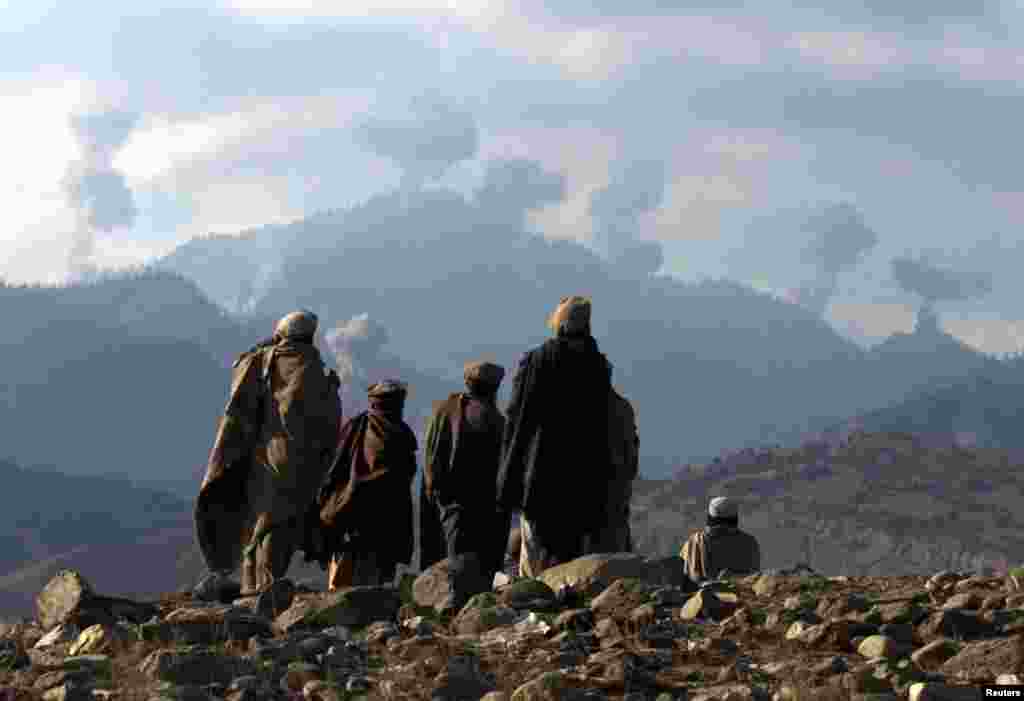 Anti-Taliban Afghan fighters watch explosions in December 2001 from U.S. bombings in the rugged Tora Bora mountains, where reports suggested Osama bin Laden might have fled.