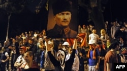 A protester holds up a picture of Turkish Republic founder Mustafa Kemal Ataturk in Istanbul.