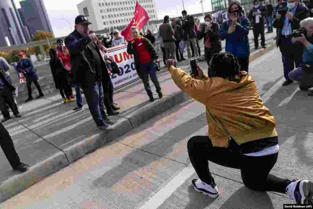 Biden supporter Angelo Austin, right, argues with a Trump supporter as they protest against the election results outside the central counting board at the TCF Center in Detroit, Mich., Thursday, Nov. 5, 2020. (AP Photo/David Goldman)