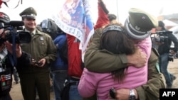 Relatives of the trapped miners celebrate with Chilean police after one of the drills working to rescue the 33 finally reached their shelter.