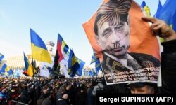 Плакат із зображенням президента Росії Володимира Путіна під час акції «Червоні лінії для Зе». Київ, 8 грудня 2019 року