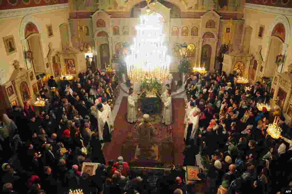 In Azerbaijan&#39;s capital, Baku, people attend an Orthodox Christmas service early on January 7, 2014.