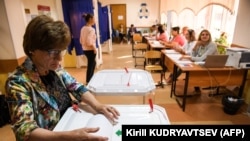 A woman casts her vote at a polling station during to Moscow City Duma elections on September 8.