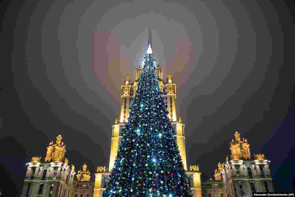 A Christmas tree stands outside a Stalin-era building, now a Radisson hotel, in the Russian capital, Moscow. (AP/Alexander Zemlianchenko)