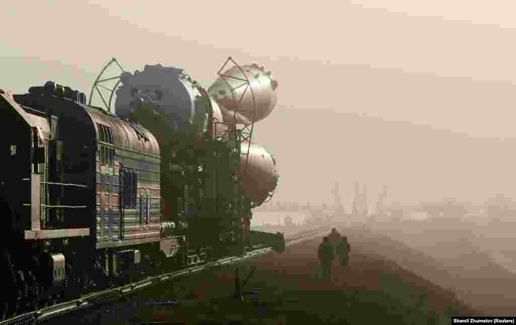Security personnel escort the Soyuz MS-08 spacecraft for the next International Space Station crew as it is transported from an assembling hangar to the launchpad ahead of its upcoming launch at the Baikonur Cosmodrome in Kazakhstan on March 19. (Reuters/Shamil Zhumatov)