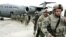 U.S. soldiers leave a plane as they arrive from Afghanistan at the Manas air base in February 2009.