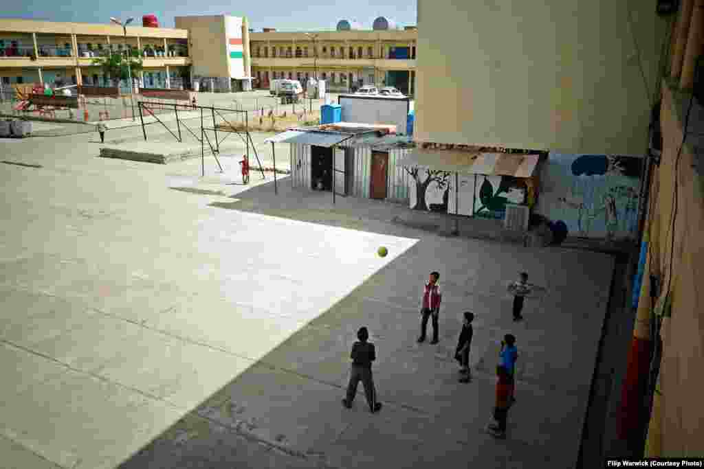 Refugee children play in the courtyard of the camp. &nbsp;