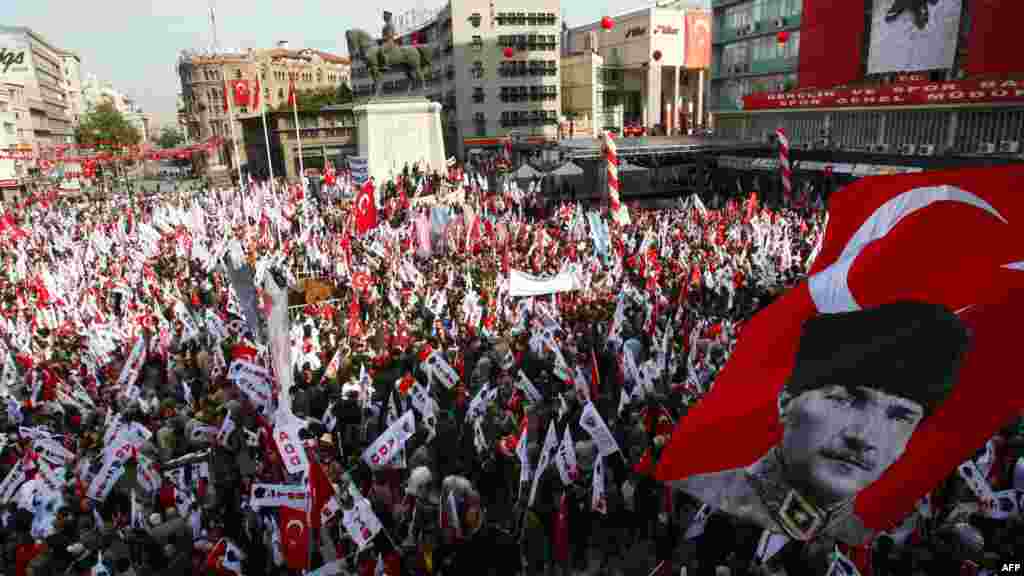 OCTOBER 29, 2012 -- A Turkish flag with a portrait of the country's modern founder Kemal Ataturk flutters above thousands of people holding national flags as they march toward the Ataturk mausoleum to celebrate Turkey's Republic Day in Ankara. 