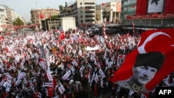 Turkey -- A Turkish flag bearing the portrait of Turkey's modern founder Kemal Ataturk floats above as thousands of people holding national flags as they march towards the Ataturk mausoleum to celebrate the country's Republic Day in Ankara, 29Oct2012