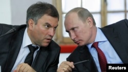 Russian President Vladimir Putin (right) talks to government chief of staff Vyacheslav Volodin, one of those sanctioned in the latest round of sanctions against prominent Moscow insiders. (left)