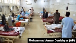 The injured receive treatment at a hospital following a suicide attack in Jalalabad on June 11.