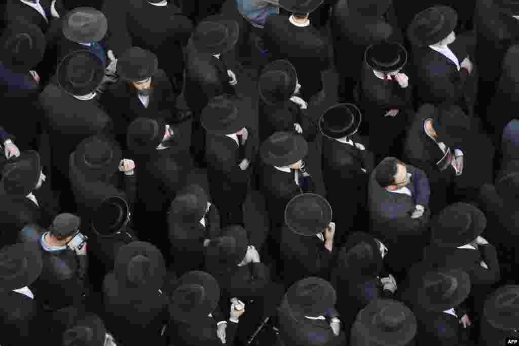 Ultra-Orthodox Jews mourn near the bodies of the victims of an attack by two Palestinians on Jewish worshippers. Four Israelis were killed at a synagogue in the ultra-Orthodox Har Nof neighborhood in Jerusalem. (AFP/Gali Tibbon)