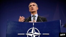 NATO Secretary-General Jens Stoltenberg gestures during a press conference at the military alliance's headquarters in Brussels on December 1.