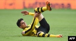 Dortmund's Spanish defender Marc Bartra lays on the field during a game against Bayern Munich on April 8.