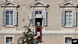 Pope Francis delivers a speech during from his studio window overlooking St. Peter's Square on December 24.